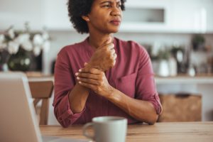 Woman Experiencing Wrist Pain While at Home